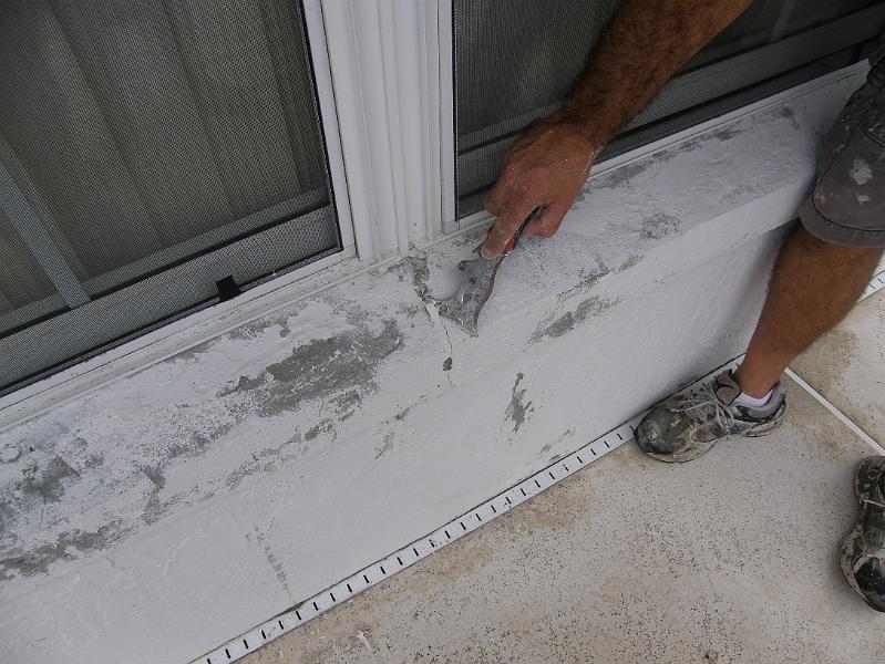 04Scraping Loose Concrete from Holes.JPG